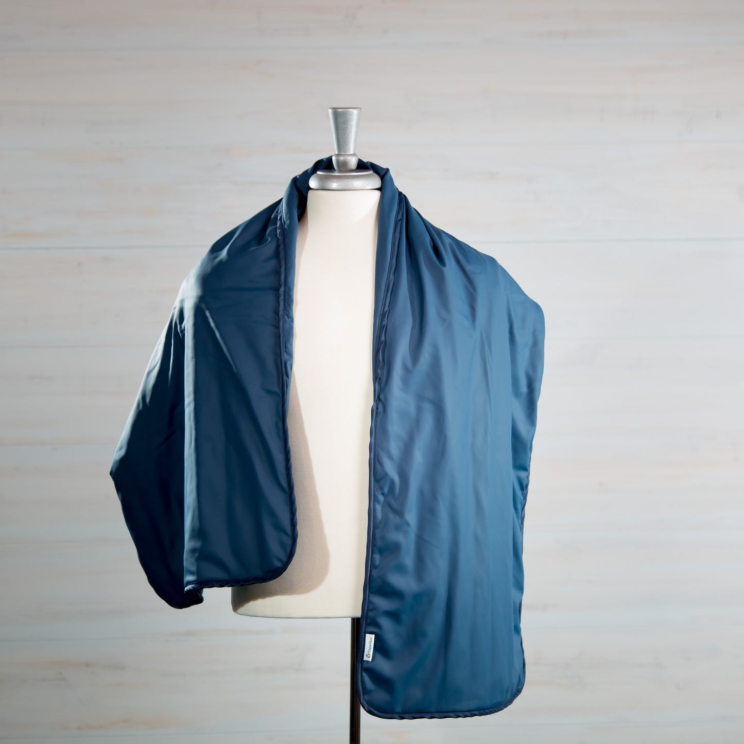 CapeAble®Care Medical Weighted Shoulder Wrap draped over a dress form mannequin, shown in navy blue with a smooth, lightweight fabric finish