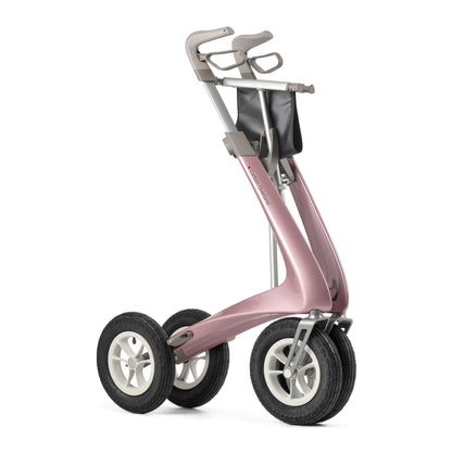 A modern three-wheel mobility rollator with a metallic dusty pink frame, gray handlebars, black tires, and silver hubcaps, shown on a solid white background.