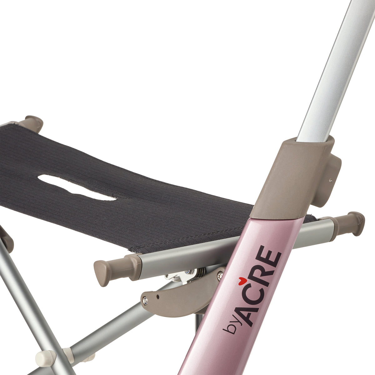 Close-up of a folding rollator frame by ACRE, showing a dusty pink metal tube with the brand name printed vertically, silver metal legs, taupe plastic joints, and a dark gray fabric seat against a white background.