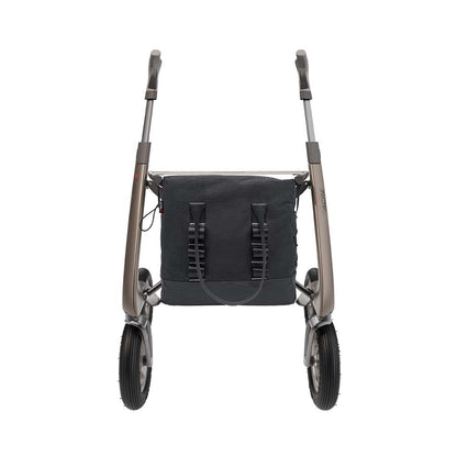 A rollator walker with a black mesh storage bag attached to the front frame, shown from the rear against a solid white background.