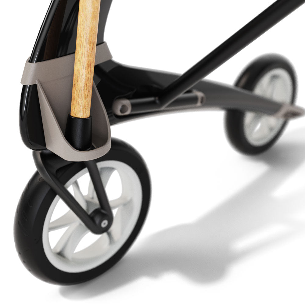 Close-up of a black rollator with cane holder on a white background