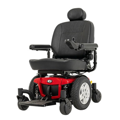 A power wheelchair with a black padded seat and armrests, a red front body panel, and black wheels, shown on a plain white background.