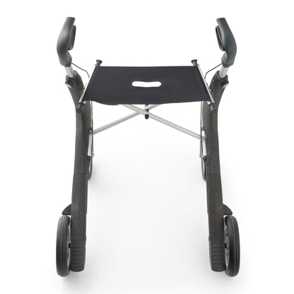 A compact four-wheel walker with a black fabric seat, black arm pads, and silver metal frame components, shown from a front-facing perspective on a white background.