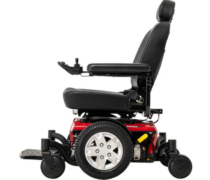 A red and black power wheelchair shown from a side profile view against a solid white background.