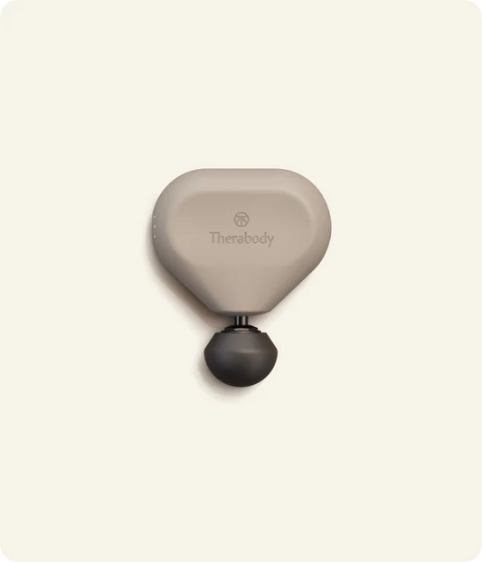 Theragun Mini 3.0 portable percussion massage gun in oat color designed for compact muscle recovery and on-the-go tension relief.