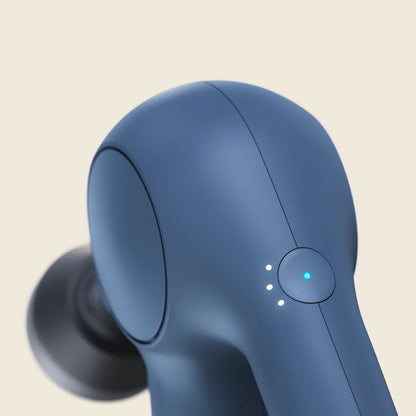 Close-up view of the navy Theragun Relief percussion massage gun showing ergonomic design and power indicator lights.