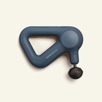 Theragun Relief percussion massage gun in navy blue designed for muscle recovery, tension relief, and everyday wellness support.