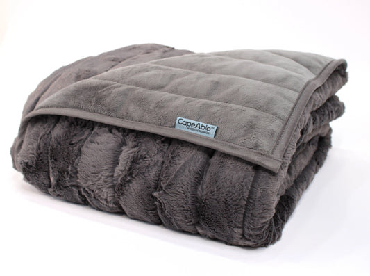 Folded CapeAble weighted blanket in mid-century ash ribbed plush with quilted gray interior lining, displayed on white background