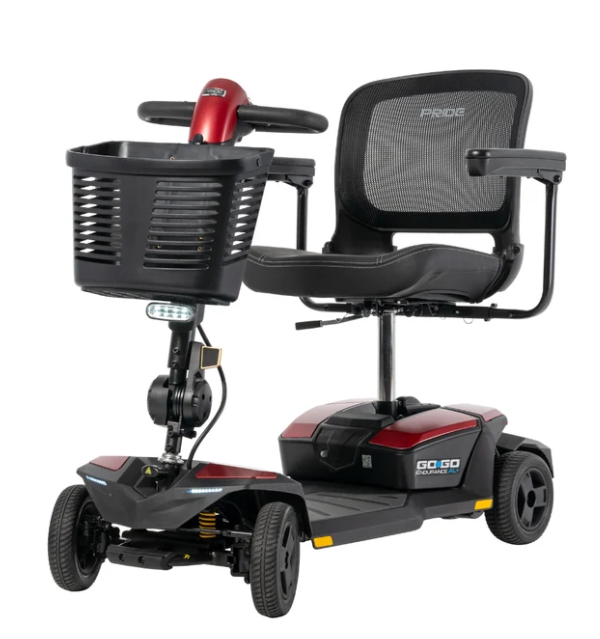 A black and red electric mobility scooter with a front basket, mesh back seat, and three wheels, shown on a plain white background.