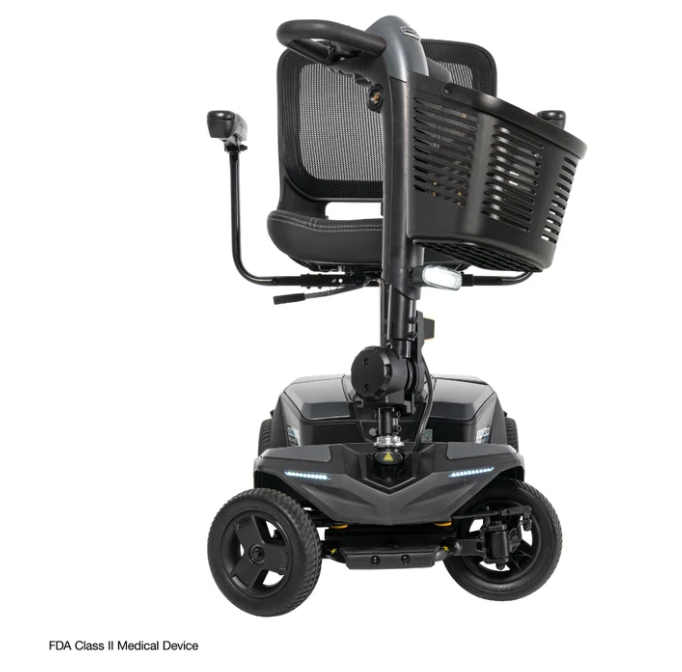 A black FDA Class II medical scooter with a high-back mesh seat, a front storage basket, and a control joystick on the left side, shown against a plain white background.