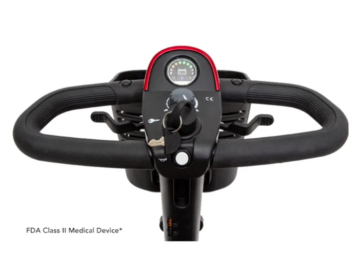 Close-up of a black electric push scooter handlebar and control console with a small red-trimmed digital display, shown on a white background with 'FDA Class II Medical Device' text at the bottom left.