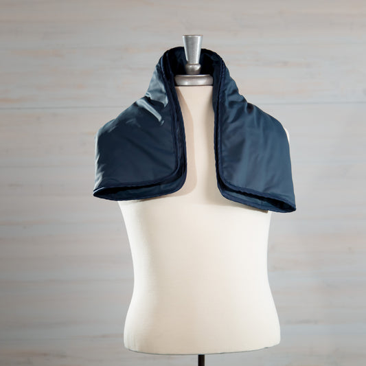 Navy medical-grade weighted lap pad displayed on a mannequin.